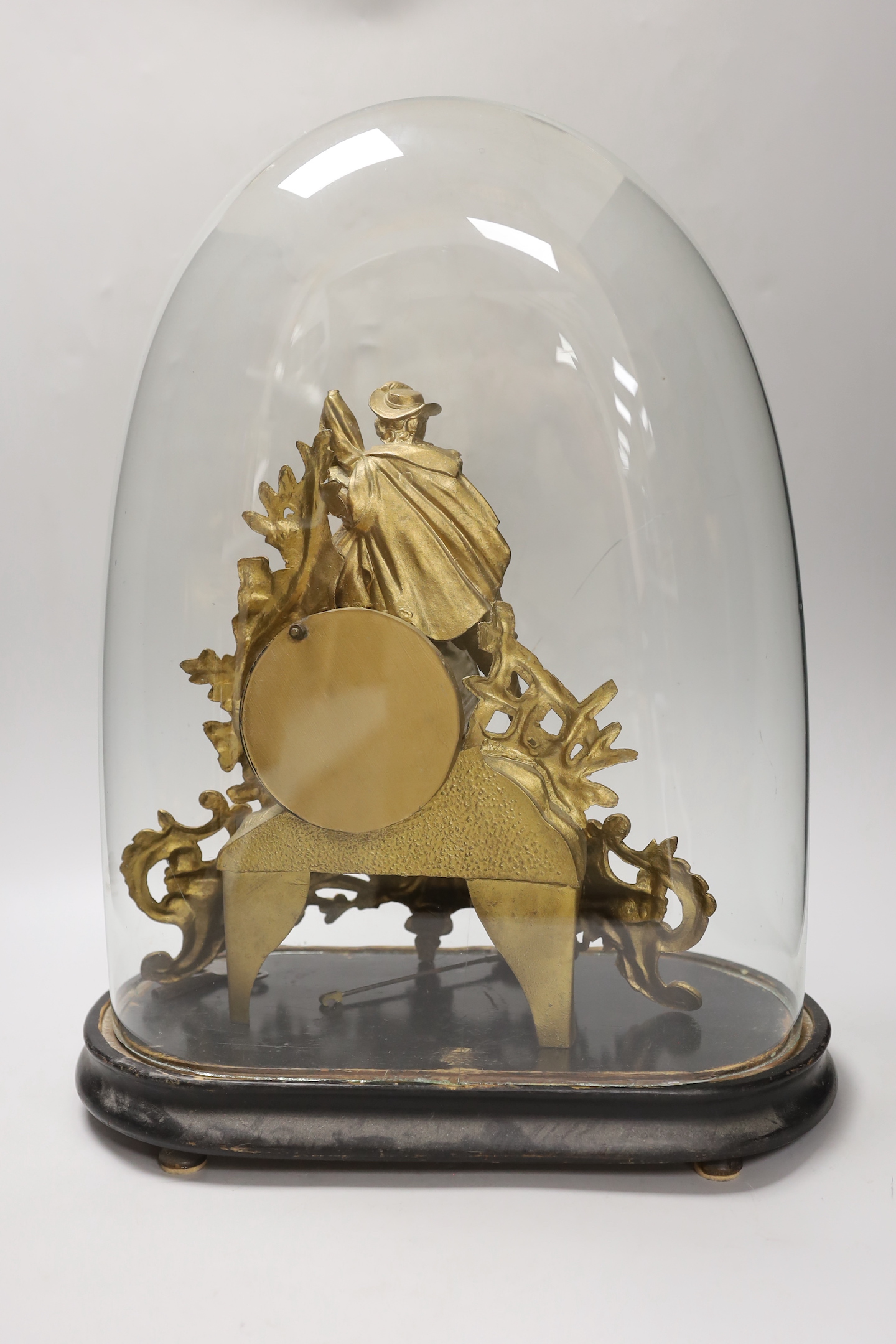 A 19th century gilt-spelter figural mantel clock, on stand under a glass dome, total height 47cm